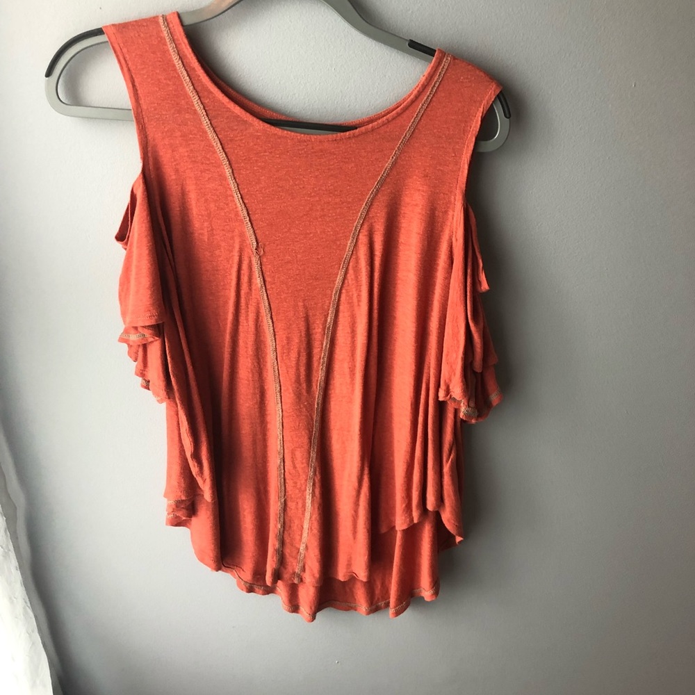 Shirt that has cut out sleeves